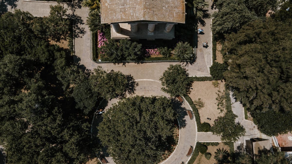 Drone photo showcasing the lush green park and historic architecture in Valletta, Malta.